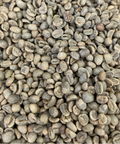 A close-up image of green, unroasted coffee beans.
